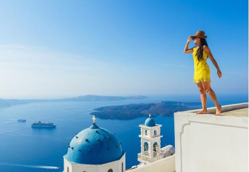 female tourist enjoys breathe taking view of santorini
