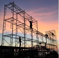 workers are doing their job with sunset background